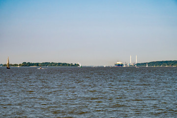 Intense ship traffic on Elbe River at sunny Sunday in late August.