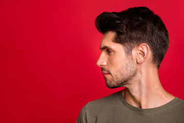Photo of macho guy turn head side showing new hairstyle wear grey t-shirt isolated on red background