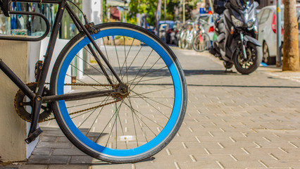 urban life style concept picture with cycle wheel center of composition in street 
