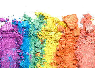 A broken rainbow colored eye shadow smear, make up palette isolated on a white background.