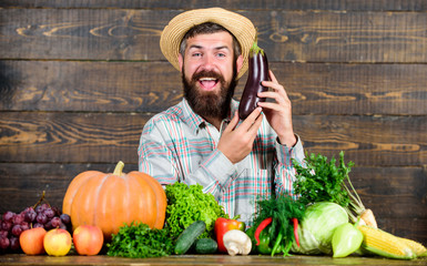 Grow organic crops. Community gardens and farms. Homegrown organic food. Healthy lifestyle. Man with beard wooden background. Become organic farmer. Farmer with organic homegrown vegetables