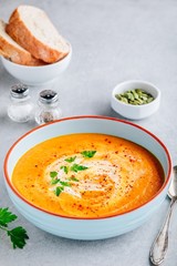 Carrot and pumpkin cream soup with parsley