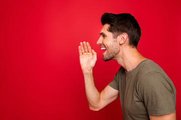 Profile photo of macho guy yelling empty space secret information wear grey t-shirt isolated on red background