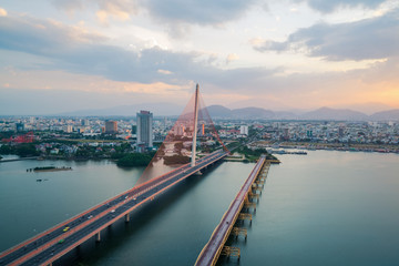 Obraz premium Han River Bridge (Cau Song Han) over the Han River in Da Nang, central Vietnam. Da Nang skyline cityscape by twilight period