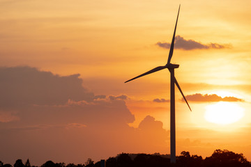 silhouette of wind turbine located on a ridge with wind blowing all the time. Making it able to...
