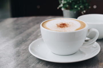 Hot coffee and hot tea place on the marble table in early morning with copyspace, white cup and silver spoon.