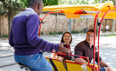 Active girl with boyfriend traveling on rickshaw