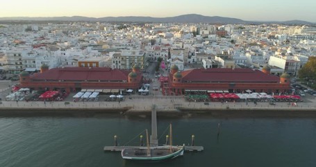 Aerial cityscape of Olhao downtown, view of ancient neighbourhoods traditional cubist architecture and landmark market. Algarve, Portugal.