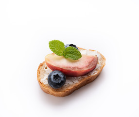 bread toast with peach and blue berry on isolated white background