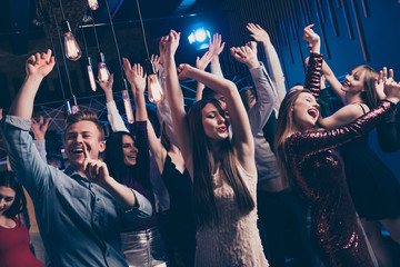 Close up photo of cute charming attractive millennial raise hands concert wear dress shirt free careless carefree feel cheerful content indoors