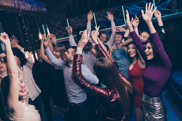 Nice-looking attractive shine smart glamorous cheerful glad positive stylish chic ladies and gentlemen having fun dj set edm festal festive occasion in fashionable luxury place nightclub indoors