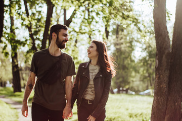 Young happy couple in love run on the sunset and smiling