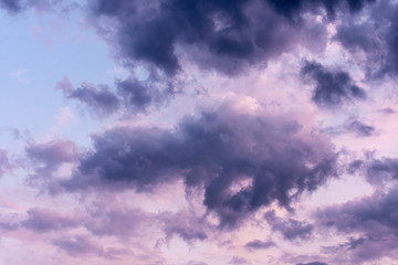 Obraz premium Blue hour sky clouds background. Beautiful landscape with stormy clouds and purple sun on sky