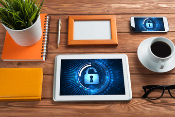 Web security and technology concept with tablet pc on wooden table