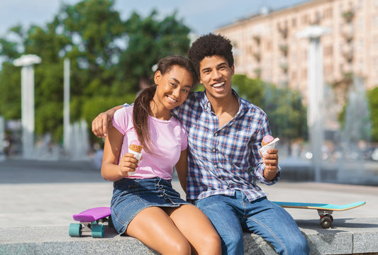 Cheerful Teenagers Having Date In The City Eating Ice Cream