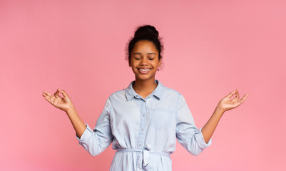 Portrait of cute teen girl holding her fingers in mudra gesture