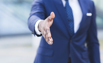 Fototapeta premium Unrecognizable African American Businessman Stretching Hand For Greeting Outdoor