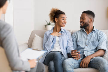 Cheerful Afro Couple Sharing News With Marital Therapist After Reconciliation