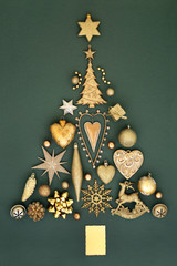 Abstract Christmas tree decoration with gold baubles, ornaments and symbols on mottled green...
