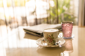 Hot coffee, latte with newspapers. Breakfast at a coffee shop.warm tone