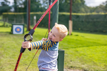 little boy playing with a bow