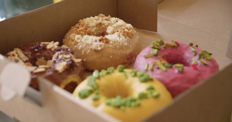 Delicious sweet colorful donuts in takeaway box