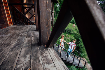 Full view, walking of two person. Couple in the wooden house resting togetherness.