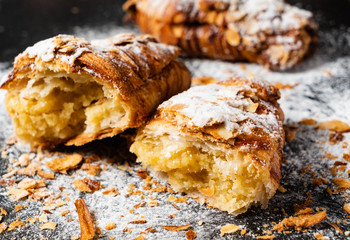 Croissants with almonds on the black background