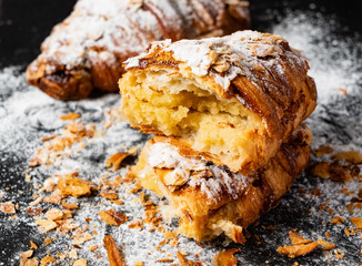 Croissants with almonds on the black background