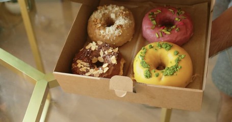 Delicious sweet colorful donuts in takeaway box