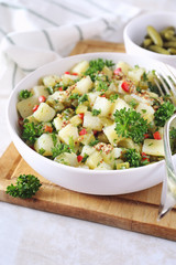 Potato salad with pickled cucumbers and parsley