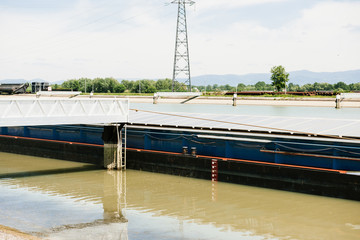 Large cargo barge tanker boat on Rhine River with Germany Black Forest Mountains in the background