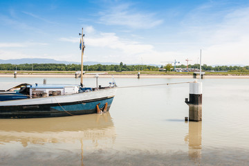 Large cargo tanker boat on Rhine River with Germany Black Forest Mountains in the background