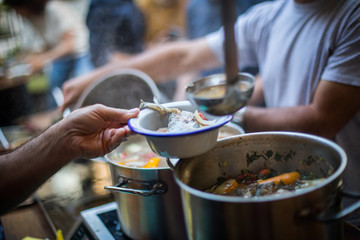 Person serving a portion of fish soup