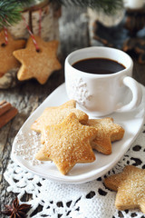 New Year composition: cup of coffee and Christmas cinnamon cookies
