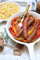 Mediterranean cuisine. Fried sausages stewed in bell pepper, onion and tomato sauce