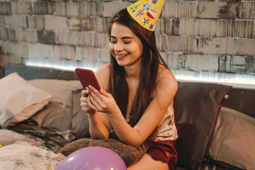 The portrait of a brunette lady responds to her birthday greetings