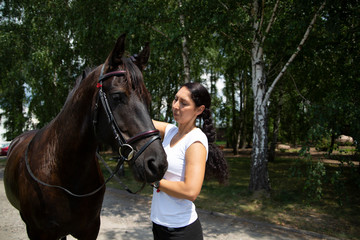 A woman and a horse at the stud. Horse Riding,