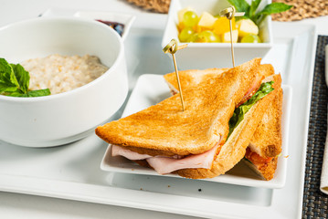 breakfast in the cafe with oatmeal and sandwich