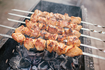 Juicy slices of meat with sauce prepare on fire shish kebab . BBQ outside.
