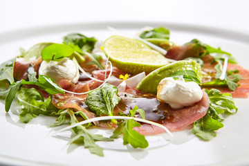 Tuna carpaccio with avocado and lime close up