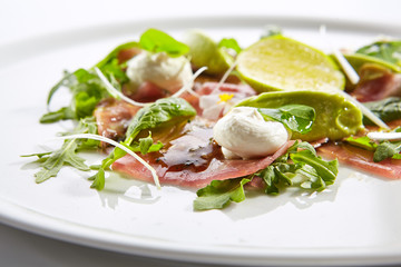 Tuna carpaccio with avocado and lime close up