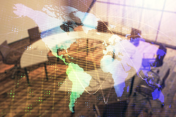 Double exposure of globe hologram on conference room background. Concept of international business