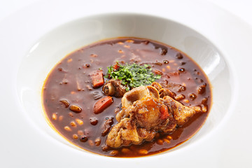 Tomato soup with beef ribs closeup