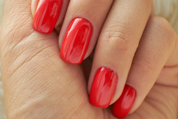 perfect red manicure. nail and hand care in the salon