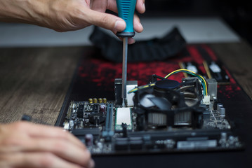 Changing devices to increase computer performance, Expert fixing the computer motherboard, Close-up