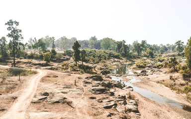 Dying rivers of a Narmada tributary in Madhya Pradesh on a scorching hot April afternoon. Dry land depicting a drought. A typical natural arid climate scenery in the rural India in a Hot Summer Day.