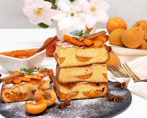 biscuit pie with apricots and fresh fruit on a black graphite board