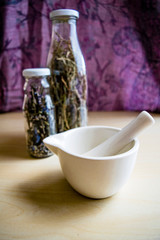 mortar and pots with dried medicinal herbs