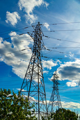 hydro electric towers under blue cloudy sky